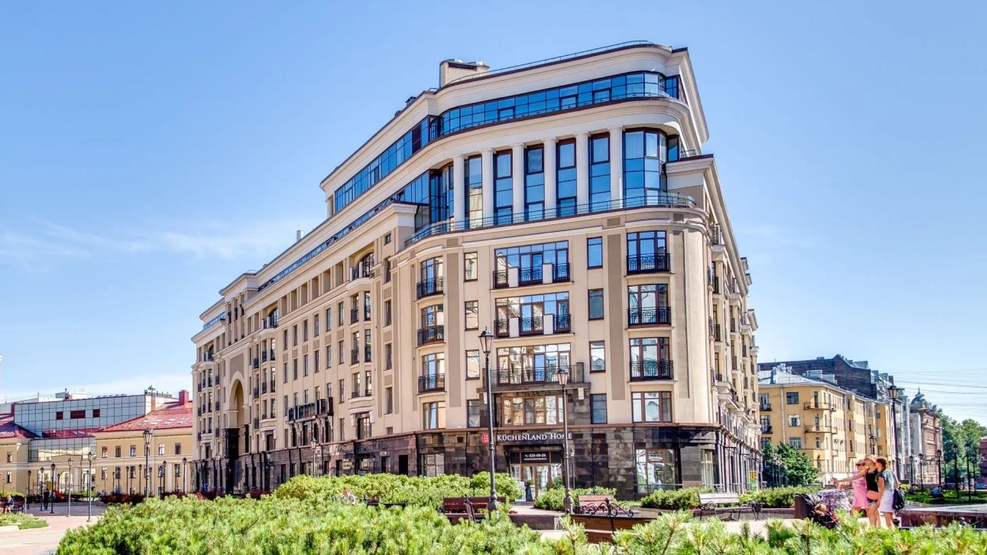 Large-scale development of Parade Quarter, showcasing classical architecture with modern elements, large windows, and premium residential and commercial spaces in an upscale urban setting.